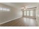 Bedroom featuring wood-look flooring, ceiling fan, and three windows with natural light at 5500 Riviera Dr, Orlando, FL 32808
