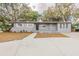 Charming single-story home with a well-maintained front yard and mature trees at 5500 Riviera Dr, Orlando, FL 32808