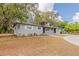 Charming gray home with front yard landscaping and mature trees at 5500 Riviera Dr, Orlando, FL 32808
