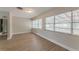 Well-lit living room featuring modern floors, neutral paint, and large windows, providing ample natural light at 5500 Riviera Dr, Orlando, FL 32808