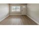 Bright living room featuring new vinyl flooring, fresh neutral paint, and a window for natural light at 5500 Riviera Dr, Orlando, FL 32808