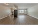 Inviting living room featuring fresh paint and modern floors, seamlessly flowing into the open kitchen at 5500 Riviera Dr, Orlando, FL 32808