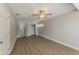 Spacious bedroom featuring updated flooring and a ceiling fan with an en suite bathroom and closet at 5500 Riviera Dr, Orlando, FL 32808
