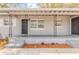 Inviting front porch with decorative iron supports, painted brick, and a cozy entrance at 5500 Riviera Dr, Orlando, FL 32808