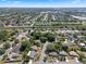 This aerial view captures the serene neighborhood with mature trees and a beautiful lake nearby at 5709 Breskin Dr, Orlando, FL 32839