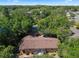 An aerial view highlights the home's backyard, surrounded by mature trees for privacy at 5709 Breskin Dr, Orlando, FL 32839