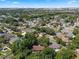 This aerial view shows the home surrounded by mature trees in a quiet neighborhood at 5709 Breskin Dr, Orlando, FL 32839