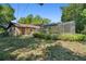 A view of the back of the house shows the pool enclosure and backyard at 5709 Breskin Dr, Orlando, FL 32839