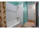 Bathroom featuring white tiled walls and a standard tub with shower, with light green walls at 5709 Breskin Dr, Orlando, FL 32839