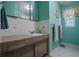 Bathroom featuring a laminate cabinet, white tile, and light green walls and a window on the right at 5709 Breskin Dr, Orlando, FL 32839
