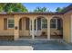 Charming home entrance featuring arched columns and decorative shutters at 5709 Breskin Dr, Orlando, FL 32839
