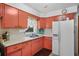 Functional kitchen with peach color cabinets and ample countertop space at 5709 Breskin Dr, Orlando, FL 32839