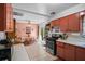 Cozy kitchen with eat-in dining area, peach color cabinets, and stainless steel appliances at 5709 Breskin Dr, Orlando, FL 32839