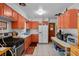 Functional kitchen with peach color cabinets and ample countertop space at 5709 Breskin Dr, Orlando, FL 32839