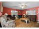 Spacious living room with ceiling fan, slider door, and cozy furniture at 5709 Breskin Dr, Orlando, FL 32839