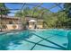 Relaxing screened-in pool area with an umbrella and seating, surrounded by the home and yard at 5709 Breskin Dr, Orlando, FL 32839
