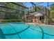 Backyard pool with screened-in patio featuring outdoor seating; the blue water offers a refreshing escape at 5709 Breskin Dr, Orlando, FL 32839