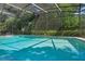 The screen enclosed pool is surrounded by mature landscaping, offering privacy at 5709 Breskin Dr, Orlando, FL 32839