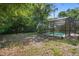 Mature trees create privacy for the screen enclosed pool in the backyard at 5709 Breskin Dr, Orlando, FL 32839