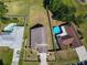 Aerial view of a home with a spacious, fenced yard, an in-ground pool and a portable pool at 602 Milan Dr, Kissimmee, FL 34758
