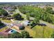 Aerial view of the property showcasing the layout, fenced in yard, and proximity to the road and surrounding neighborhood at 602 Milan Dr, Kissimmee, FL 34758