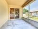 A sunny back porch with a view of a home's backyard through a sliding glass door at 602 Milan Dr, Kissimmee, FL 34758