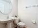 Clean half-bathroom with pedestal sink, toilet, and neutral walls, offering a functional space at 602 Milan Dr, Kissimmee, FL 34758