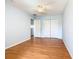 This light blue bedroom features a ceiling fan, closet, laminate wood flooring, and window at 602 Milan Dr, Kissimmee, FL 34758