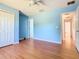 Bedroom with laminate flooring, large closet, and light blue walls at 602 Milan Dr, Kissimmee, FL 34758