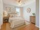 Stylishly staged bedroom with neutral decor, ceiling fan, and window for natural light at 602 Milan Dr, Kissimmee, FL 34758