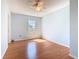 This light blue bedroom has a ceiling fan, a window, and laminate wood flooring at 602 Milan Dr, Kissimmee, FL 34758