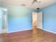 Empty bedroom features laminate flooring, large closet, and light blue walls at 602 Milan Dr, Kissimmee, FL 34758