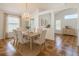 Elegant dining room with chandelier, neutral decor, and large windows offering ample natural light at 602 Milan Dr, Kissimmee, FL 34758
