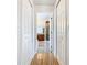 Hallway leading to primary bathroom offering ample storage space with multiple closets on either side at 602 Milan Dr, Kissimmee, FL 34758