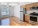 This kitchen features wooden cabinets, stainless steel appliances, and a decorative tile floor at 602 Milan Dr, Kissimmee, FL 34758