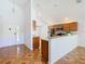 This open-concept kitchen features wooden cabinets, granite countertops, stainless steel appliances, and white walls at 602 Milan Dr, Kissimmee, FL 34758
