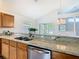 This kitchen features wooden cabinets, granite countertops, stainless steel appliances, and an undermount sink at 602 Milan Dr, Kissimmee, FL 34758