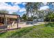 Expansive backyard with lush greenery, swimming pool, and covered patio at 659 N Endeavour Dr, Winter Springs, FL 32708