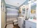 A bathroom with double vanity, shower and patterned shower curtain with matching rug at 659 N Endeavour Dr, Winter Springs, FL 32708