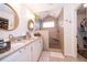 The bathroom has double sinks, granite countertops, and a tiled walk-in shower with a small window at 659 N Endeavour Dr, Winter Springs, FL 32708