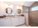 Bathroom featuring double sinks, granite countertops, tiled walk-in shower and small window at 659 N Endeavour Dr, Winter Springs, FL 32708