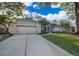 Charming single-story home with a well-manicured lawn, a long driveway, and an attached two-car garage at 659 N Endeavour Dr, Winter Springs, FL 32708