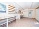 Spacious garage with tile flooring, workbench, shelving and storage at 659 N Endeavour Dr, Winter Springs, FL 32708