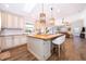 A kitchen featuring a wood-top island, two pendant lights and seating with hardwood floors throughout at 659 N Endeavour Dr, Winter Springs, FL 32708