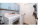 Laundry room with side by side washer and dryer, overhead storage and access to the exterior at 659 N Endeavour Dr, Winter Springs, FL 32708