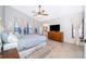 The main bedroom featuring a ceiling fan, large windows, and a view to the ensuite bathroom at 659 N Endeavour Dr, Winter Springs, FL 32708