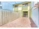 Brick-paved backyard featuring a sliding glass door to the main living area, offering an inviting outdoor space at 7484 Canford Ct # 8, Winter Park, FL 32792