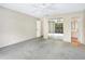 Bright bedroom with neutral walls, carpet, ceiling fan, mirrored closet and access to a balcony at 7484 Canford Ct # 8, Winter Park, FL 32792
