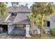 Inviting home exterior with a carport, lush landscaping, and a charming walkway at 7484 Canford Ct # 8, Winter Park, FL 32792