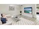 Bright living room with modern decor, soft textures, and a large television at 7484 Canford Ct # 8, Winter Park, FL 32792